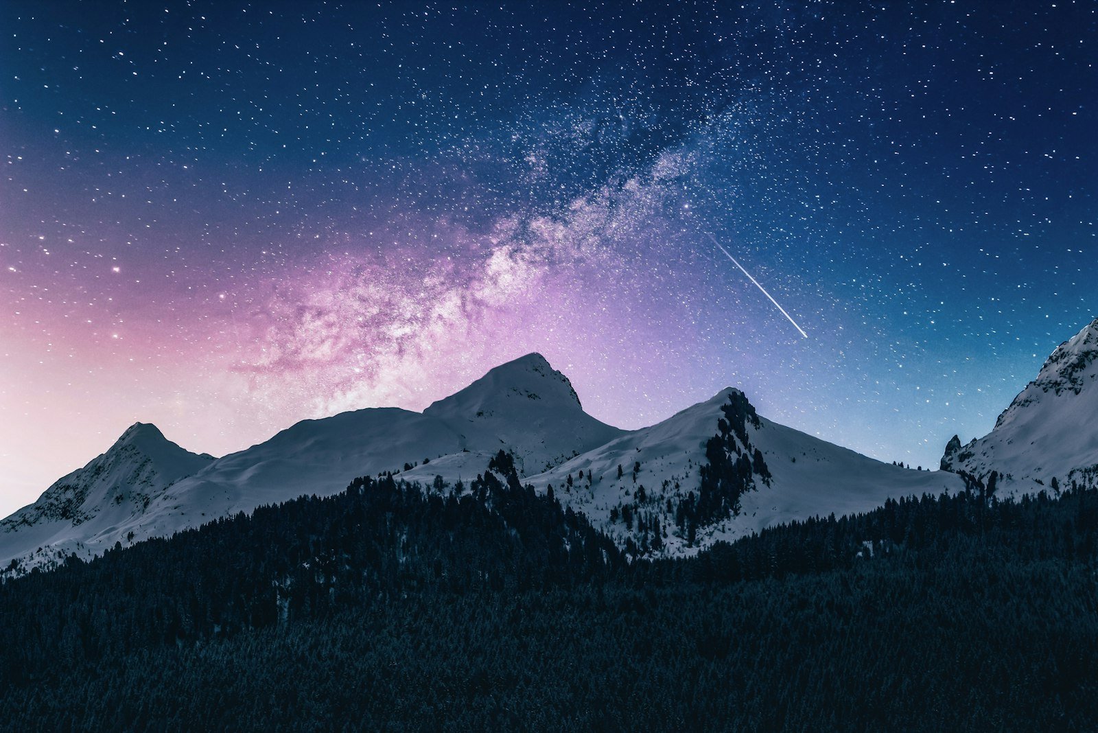 A dense field of stars above dark hills.