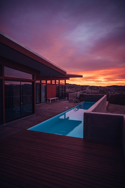 The pool terrace as the sky goes red behind the hills.