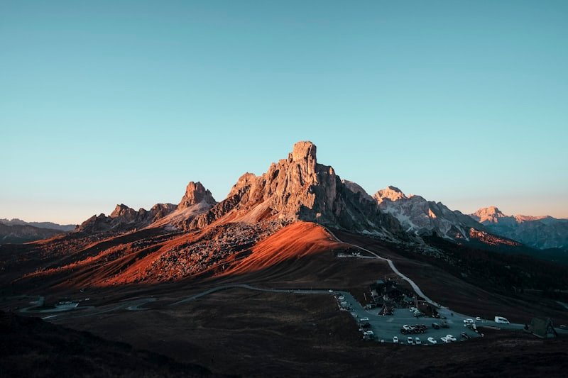 Rust-coloured rock catching the first sun along a ridgeline.